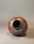 This signed handcrafted stoneware vase is a stunning example of artisan ceramic craftsmanship, featuring an organic,...