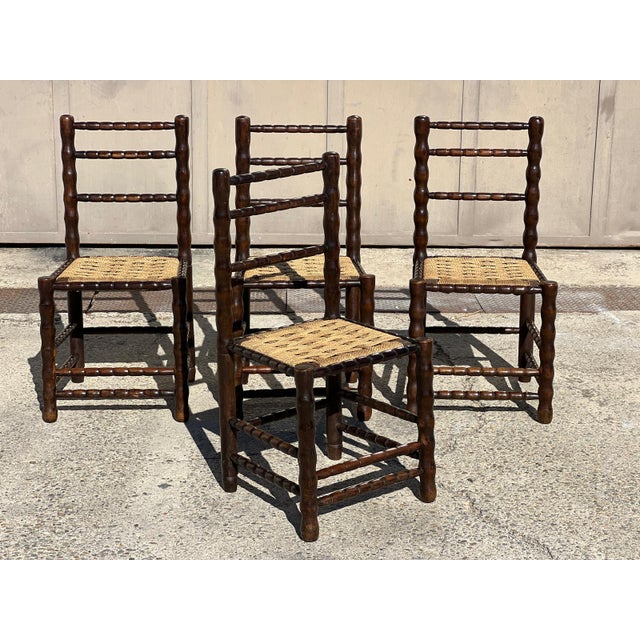 Set of four chairs with spool legs in blackened wood, attributed to Charles Dudouyt, 1940. Braided rope seats. Very good...