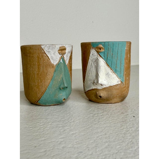 A set of four handmade mezalita glasses from an artisan family in Oaxaca. Finely decorated and painted with various...