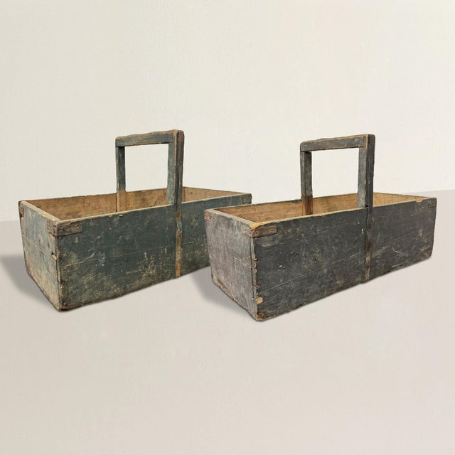 These charming early 20th-century French wooden garden trugs exude rustic elegance and historical charm. Painted a dark...