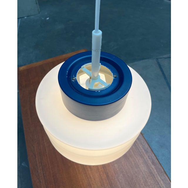 Simple Space Age pendant lamp from Staff. The large glass diffuser is striking. The photo on the top is in a dark blue...