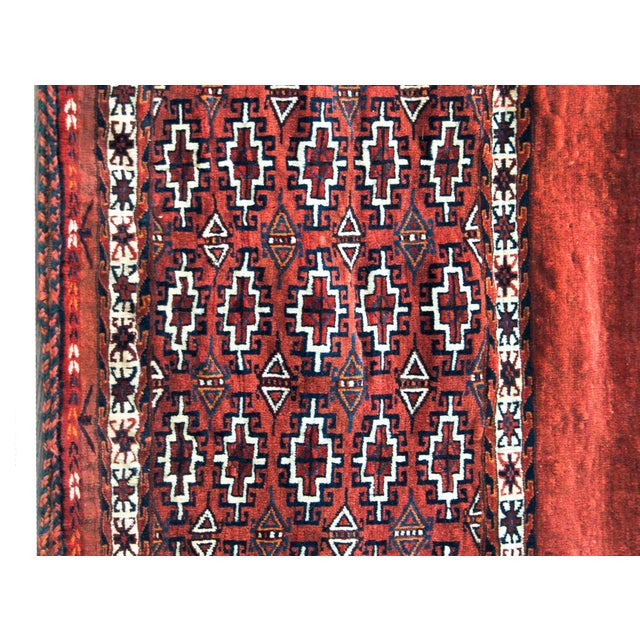 A charming early 20th century Persian Yamut bag face rug with an all-over pattern with diamonds and stylized flowers woven...