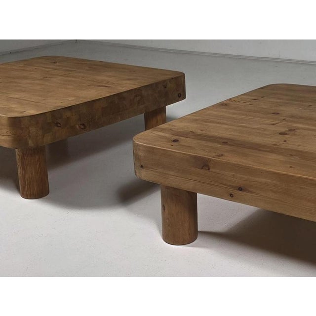 French coffee tables crafted from solid pine, dating from the 1970s. The tables feature a thick square top with softly...