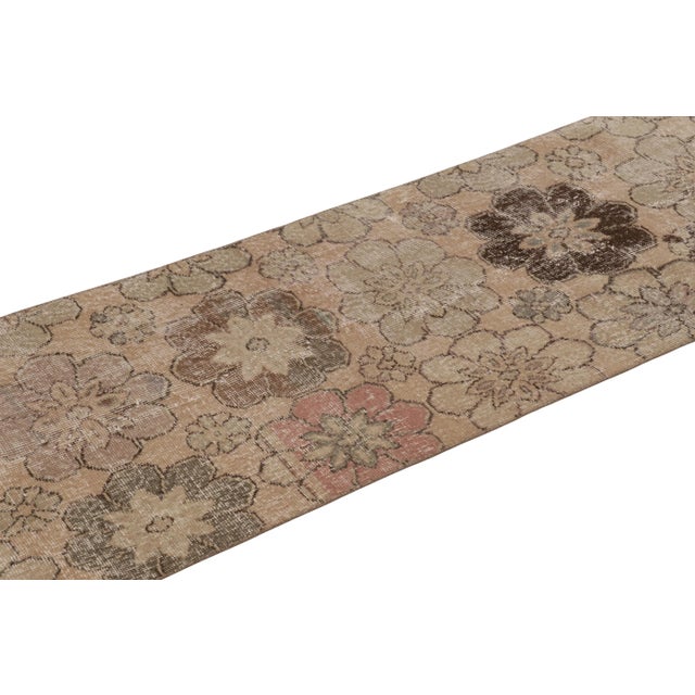 This vintage runner rug is a 2x9 Turkish distressed piece, made with hand-knotted wool circa mid-20th century. It is an...