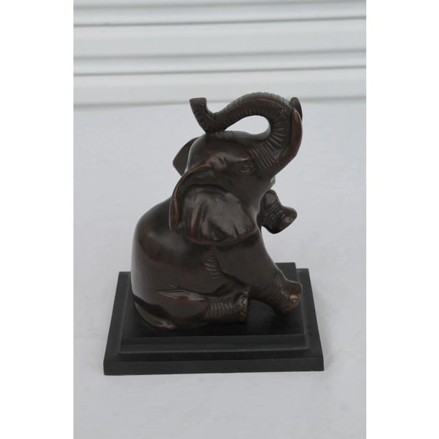 Vintage Pair of Art Deco Baby Elephant Bookends. Crafted from sturdy metal with a rich bronzed finish, these delightful...
