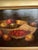 An atmospheric antique European still life oil painting [on Panel- wood board] depicting an elegant arrangement of fruit...