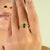 This elegant bypass ring showcases two natural pear-cut emeralds totaling approximately 0.87 carats, beautifully set in...