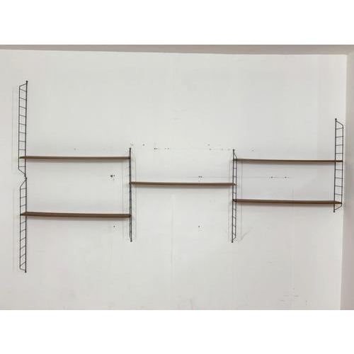 For sale is a stylish String shelving unit in a timeless mid-century design. This iconic shelving system impresses with...