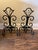 Elegant vintage wrought iron fireplace andirons featuring sculptural scrollwork and a stylized fleur-de-lis form. Hand-...