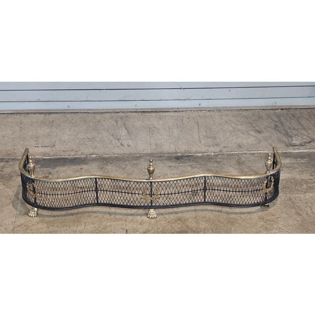 Store Item: Brass and Steel Woven Serpentine Fireplace Fender with Wreath Designs & Paw Feet Description: Steel Woven...