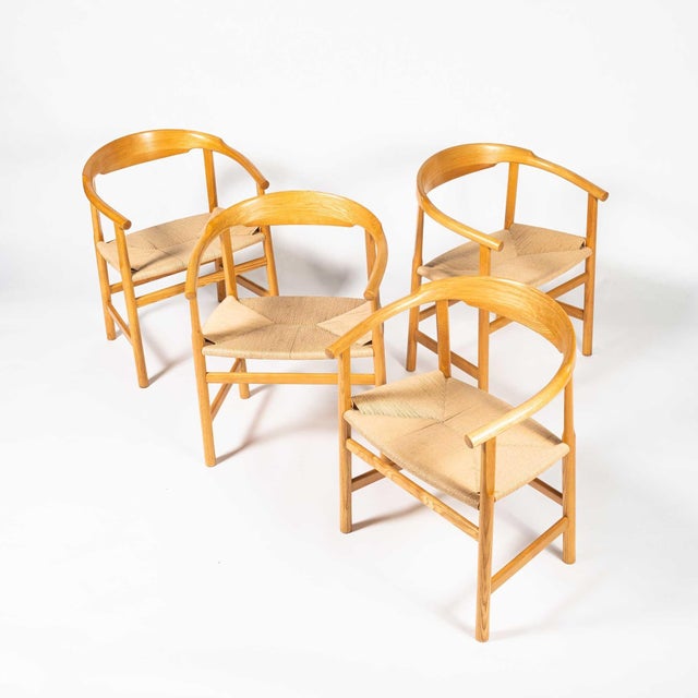 A rare set of four PP209 Hans Wegner armchairs in oiled oak and paper-cord, produced by PP Møbler (for DSB ferries),...