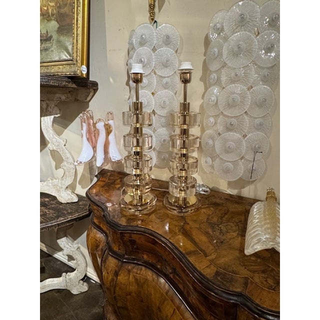 Gorgeous pair of gold Murano glass and brass disc lamps. Creates a beautiful upscale modern look! 22h x 6.5w