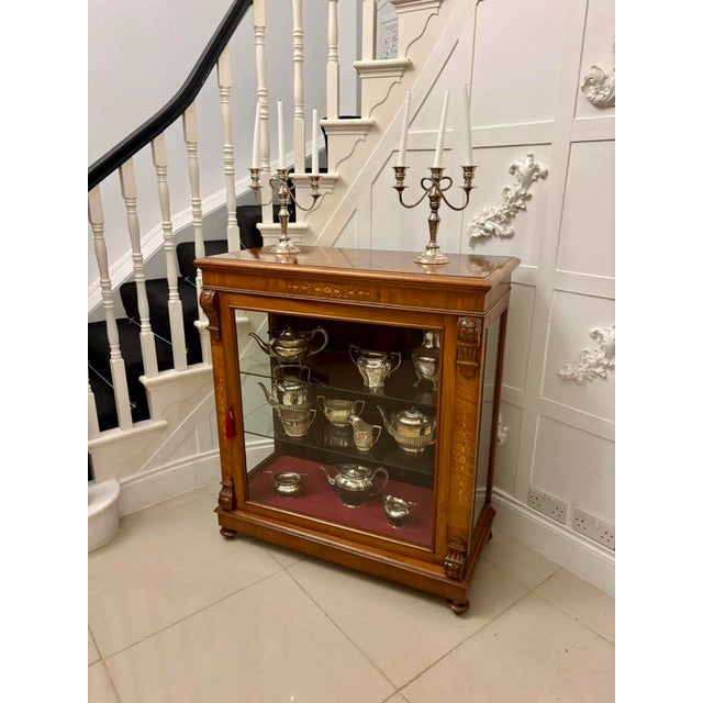 A handsome antique Victorian mahogany side / display cabinet distinguished by its fine inlay and elegant proportions. The...