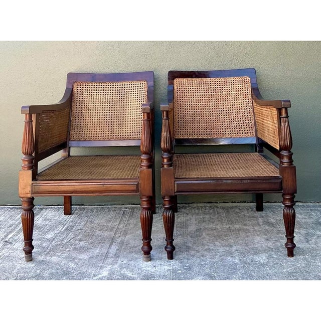 These vintage carved wood and cane chairs bring a warm, relaxed presence to a living room, reading corner, or bedroom....
