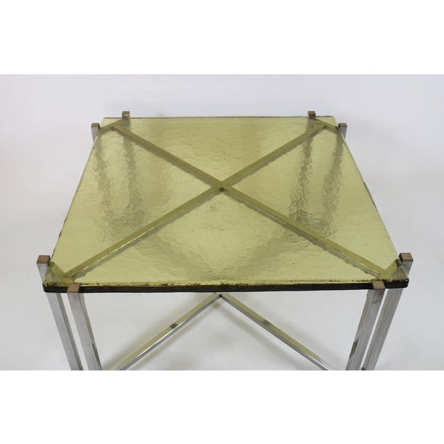 Elegant vintage coffee table from the 1970s with an all-stainless steel frame and a green glass top. Origin: Italy Period:...