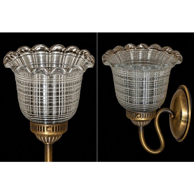 9.5" Leght 9.5" Weight 6" Depth Elegant vintage wall sconce featuring an aged brass-finish frame and a beautifully...