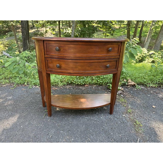 Ballard Designs Newport Demilune Table . it features curved drawers, tapered legs, half-moon lower shelf, metal knobs...