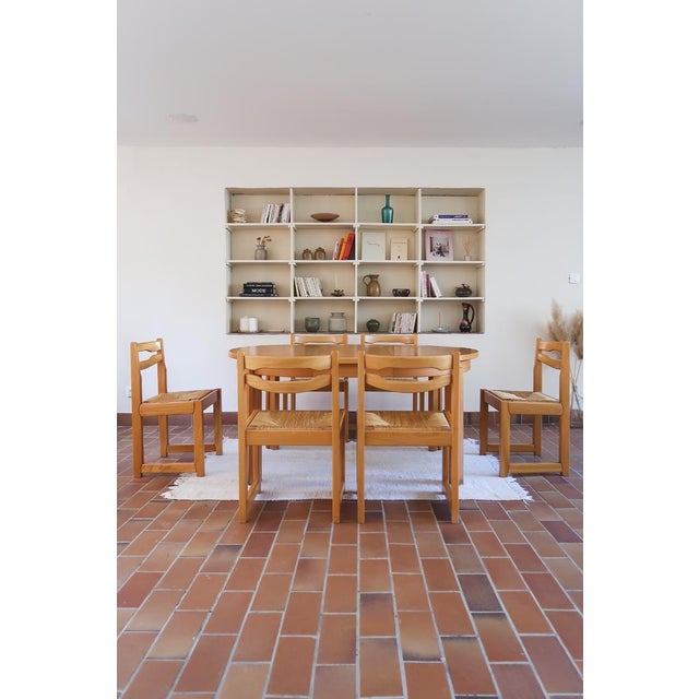 A set of six dining chairs produced by Maison Regain in the 1980s. Solid elm frames with hand-woven rush seats — sturdy,...