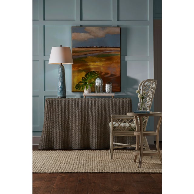 Inspired by ocean waves, the savannah console flows beautifully in a waterfront environment. Handwoven in gray wash wicker...