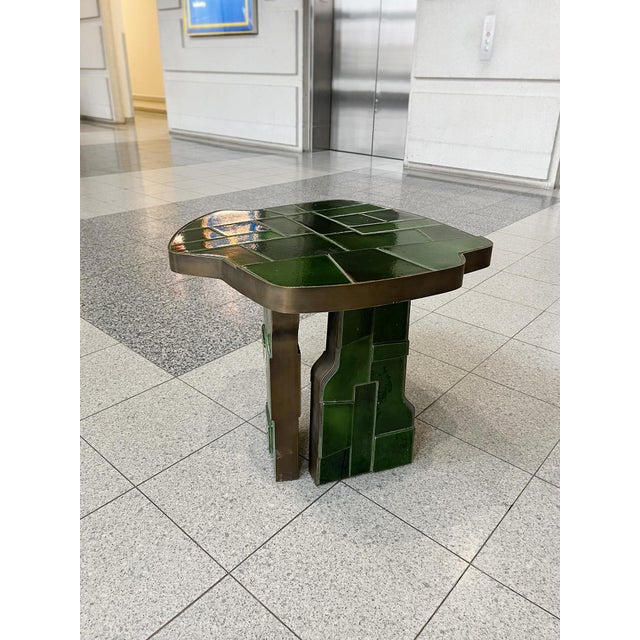 Hand-crafted in Italy, this uniquely shaped side table is ceramic and bronze. The ceramic was fired using the Japanese...