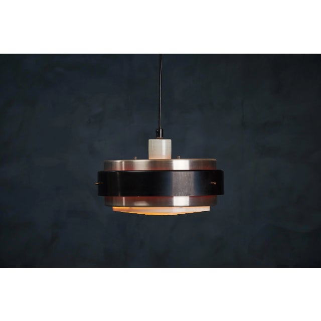 - Pendant designed in the 1960s in Denmark - It has a black outer shade and orange inner shade creating an amazing light...