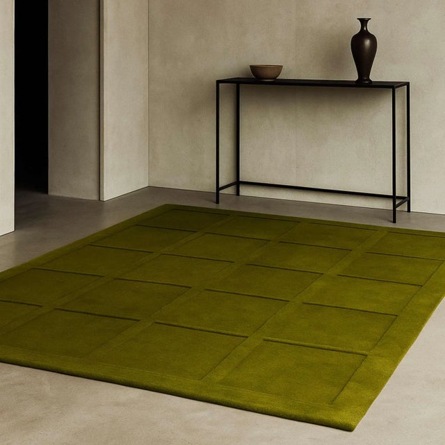 The Evergreen rug in rich moss-green tones features irregular, squared patterns inspired by the energy of nature. A...