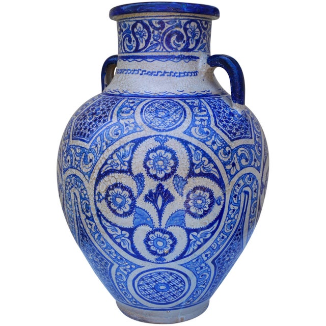 Antique handcrafted and glazed ceramic vase with handles. Exhibits an intricate hand-painted blue and white Moorish...