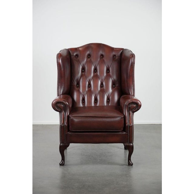 This elegant cowhide wing chair is the perfect addition for Chesterfield furniture enthusiasts. Its beautiful red color...
