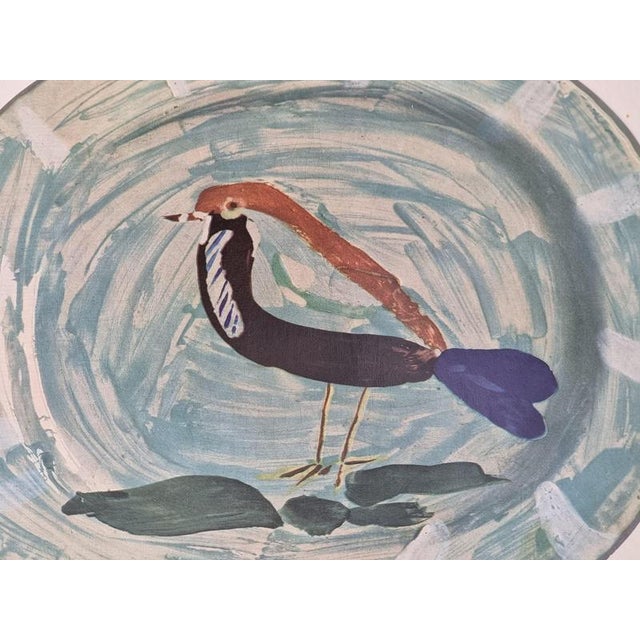 An exquisite shiny polychrome print of Picasso Vallauris ceramic plate depicting a bird in blue. The color print is...