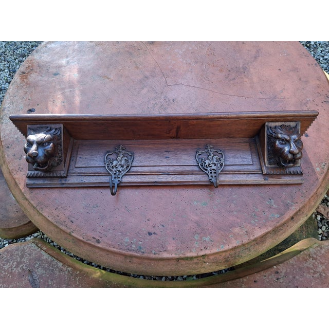 A stunning wall-mounted coat rack made of oak, adorned with hand-carved predator heads. The hooks are also unique,...