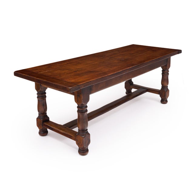 French farm table circa 1900 made of solid oak. This piece has been finished with a hand-applied natural wax. The legs are...