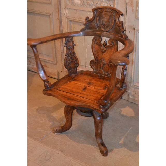 19th century Swiss hand carved wood chair with central cartouche and what appears to be a coat of arms, a carved molding...