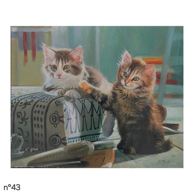 Signed oil on canvas by G. Pascut, circa late 20th century, depicting two playful kittens beside a patterned cushion in an...