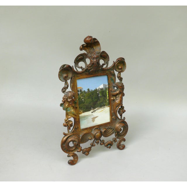 An impressive picture frame with typical Neo-Baroque stylistic elements – Neptune flanked on the right and left by a...