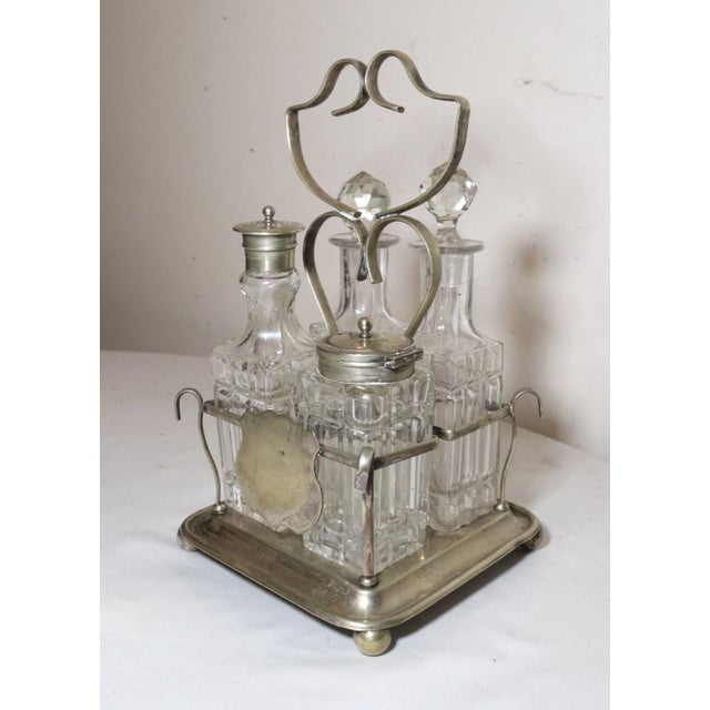 Up for sale is a wonderful antique 19th century nickel plated EPNS cruet set. it's a 4 piece set consisting of an oil, a...