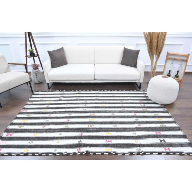 Vintage Turkish Hand-Knotted vintage rug is a semi-Vintage kilim area rug.'70s Eastern region of Turkey's unique rug is...