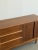 W54 D18.75 H31 This restored mid century credenza crafted from walnut offers practical storage through different concealed...