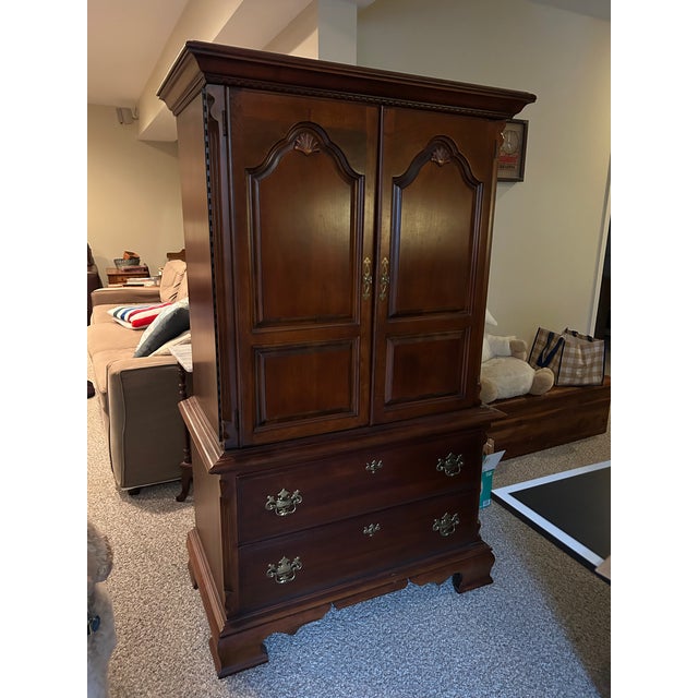 Cherry armoire with doors for a TV and then drawers underneath. Adjustable shelves and removable back for TV wires.