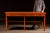 Industrial painted pine hardware store counter or merchant's workbench featuring a plank top with rounded front corners...