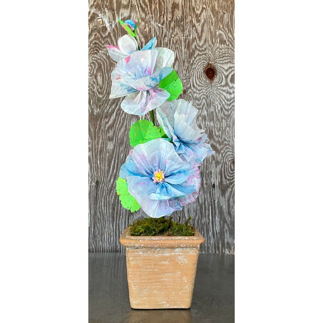 Contemporary hand-rolled paper flowers are a modern, artistic take on traditional floral arrangements. These flowers are...
