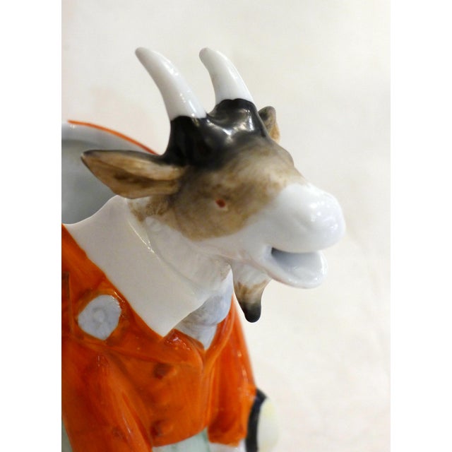 Small zoomorphic goat pitcher/cream pot, depicted seated and dressed like a human in a smart man's suit, giving it a...