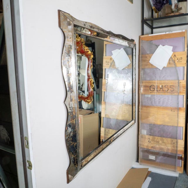 Beveled surround antique gold vein mirror. Minor crack at bottom of mirror.