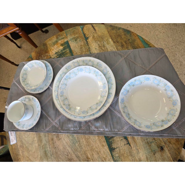 Vintage Noritake "Blue Charm" pattern. Soft light-blue daisy-like floral motifs with a subtle green accent and platinum...
