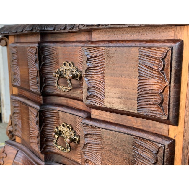 A French chestnut two-drawer commode from the late-19th century with ribbon-carved moldings and carved skirt. This petite...