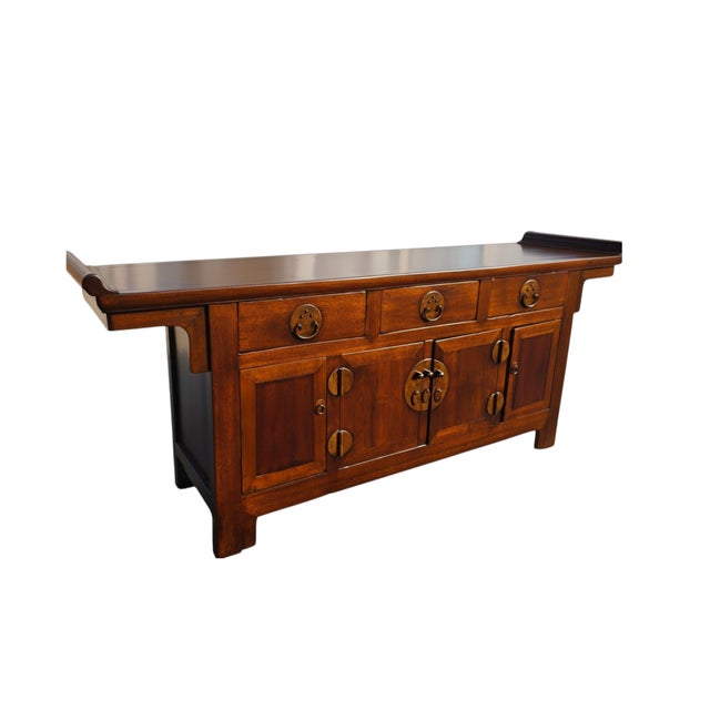 This mid-19th century sideboard is made from solid catalpa wood with a warm golden-brown finish. The top features...
