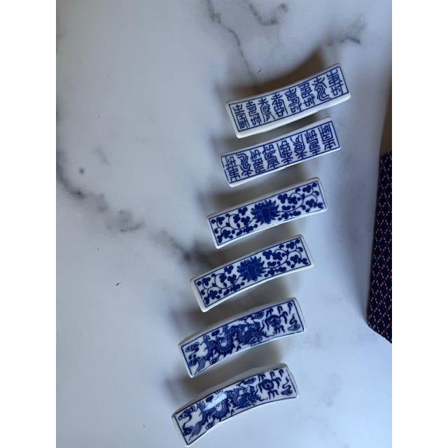 Sweet mid-century set of Asian chopstick rests. 6 rests are made of lue and white porcelain. In original fabric box with...