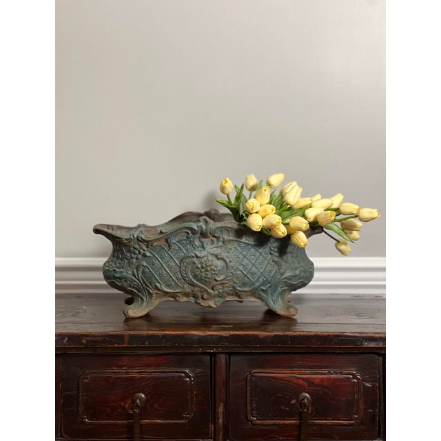 Late 19th century French patinated cast iron footed jardiniere with an oblong form in an aged green painted finish. A...
