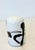 Black figure set in white under thick clear glass, heavy for its size. Probably 1970s to 80s. Marked on the base: NGS, the...
