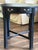 An exceptional antique round accent table showcasing a striking blend of classic Chinoiserie aesthetics and excellent...
