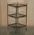 This pair of stunning mid century modern brass and smoked glass Etagere tables in the Maison Jansen style. A truly...
